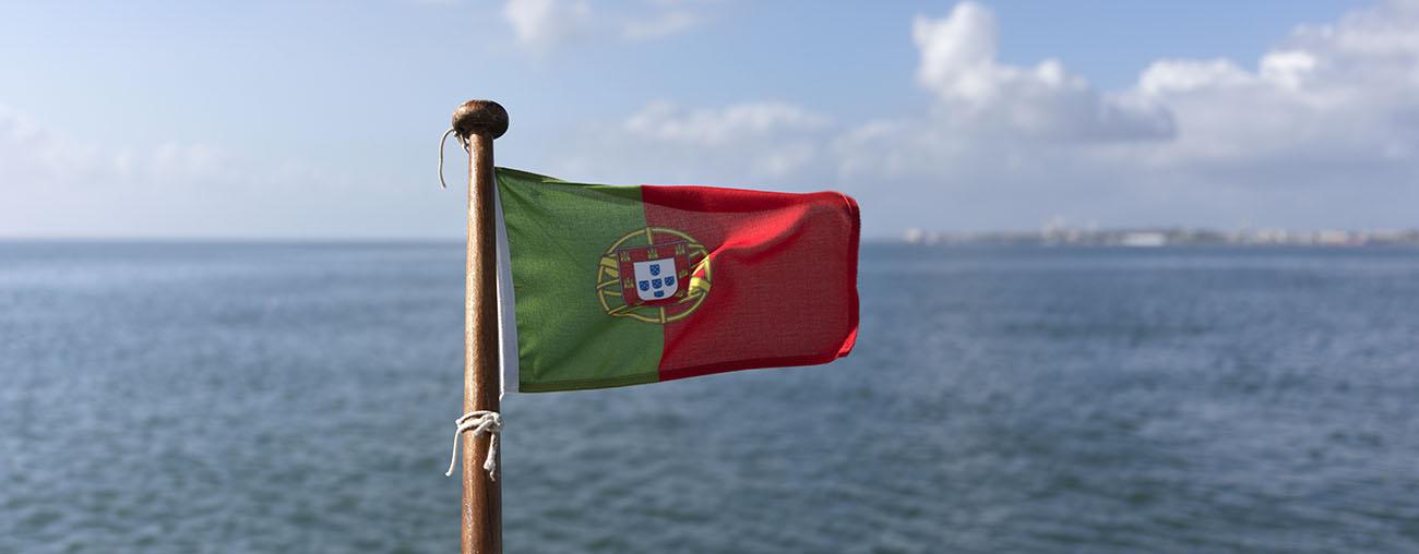 Flag of Portugal waving on the back of a boat