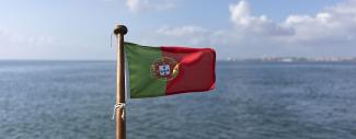 Flag of Portugal waving on the back of a boat