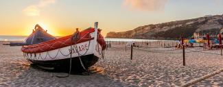 A traditional boat on the beach in Nazaré Portugal